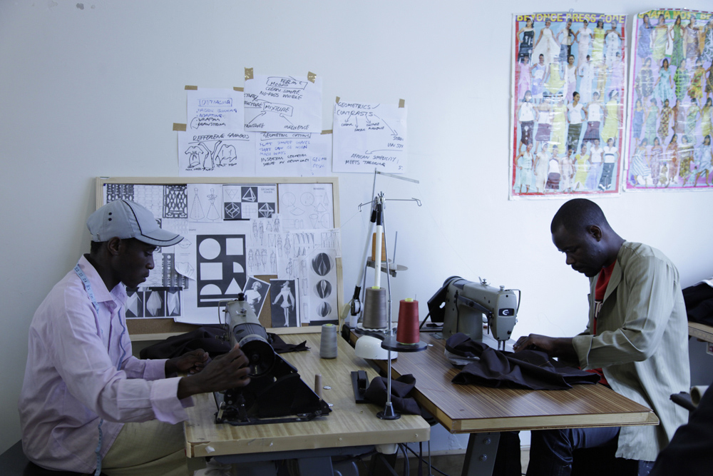 Manufacturing apprentices James and Evariste working in the upstairs fashion school. The pair, who worked together in a factory in Burundi before migrating to Australia, are best friends who love to dance.